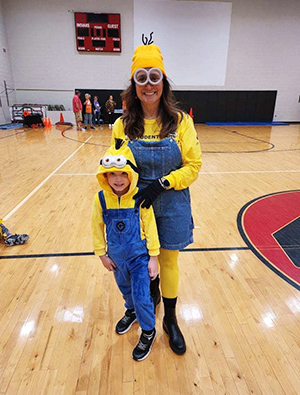 Student and adult dressed as Minions