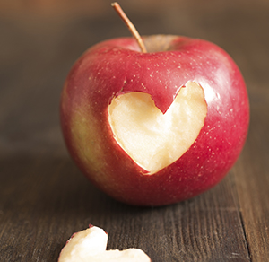 Red apple with a heart-shaped bite