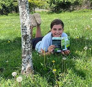 student reading under a tree