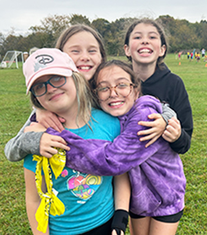 Group of students hugging outside