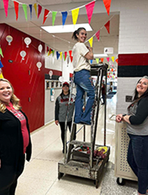 PTA parents decorating hallway