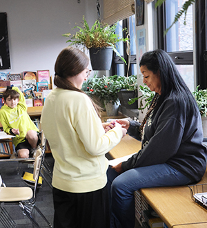 Two women talking in a classroom