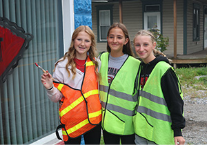 Three students with safety vests on