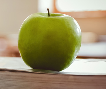 green apple sitting on desk