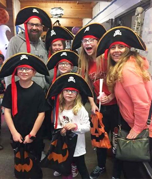 Group of happy adults and students dressed up as pirates