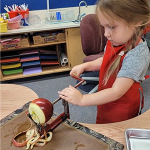 Student peeling an apple