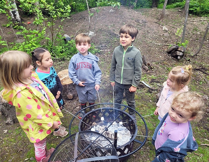 Group of students roasting marshmallows