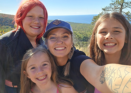 Teacher taking a selfie with three happy girls