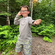 Happy student holding up a sparkler at camp