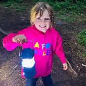 Student holding a lantern at camp