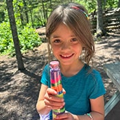 Girl holding a colorful container
