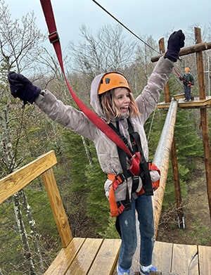 Female student excited to be on the rope course