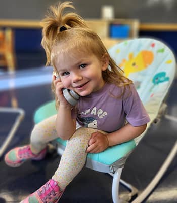 Seedling talking on toy phone