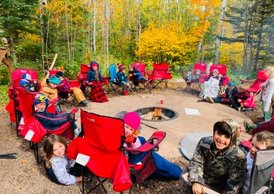 Students sitting around a fire pit outside
