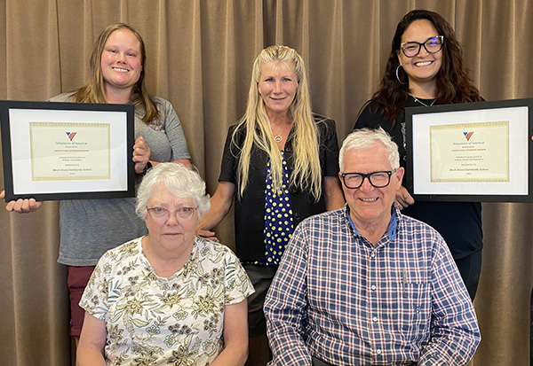 School board members posing with certificates