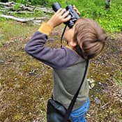 Student looking through binoculars