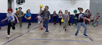 Students playing with colored balls