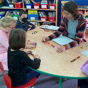 Students with teacher at a table