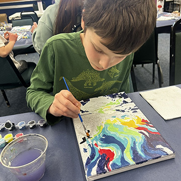 Student painting with watercolors