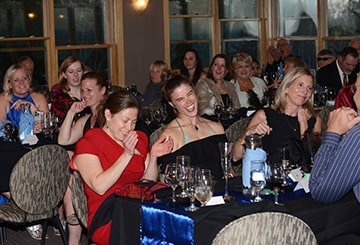 Group of guests laughing at their tables