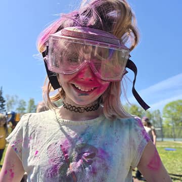 Student wearing googles covered in chalk