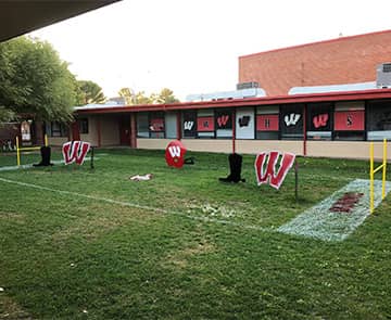Outside of the school with a miniature football field on the yard