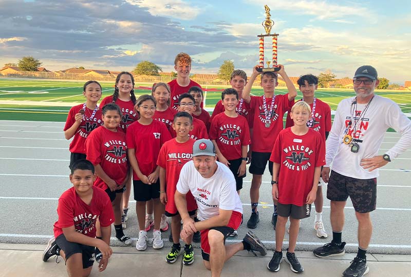 Cross country boys team holding a trophy