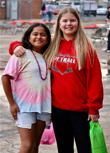 Two students hugging