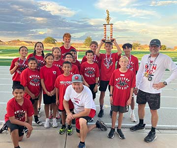 Students holding a trophy