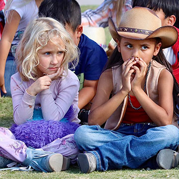 Students sitting outside on the grass Students sitting outside on the grass