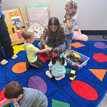 A teacher working with preschool students A teacher working with preschool students