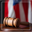 judges gavel with american flag behind it