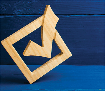 check mark in a box shaped out of wood