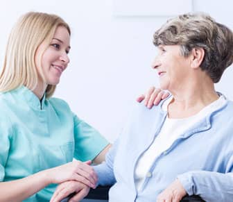 Nurse helping an elderly woman