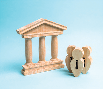 Court workers made out of wood next to wooden courthouse