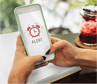 Woman monitoring public notice alerts on her phone