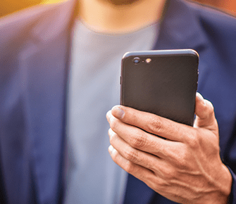 Adult in business jacket checking phone