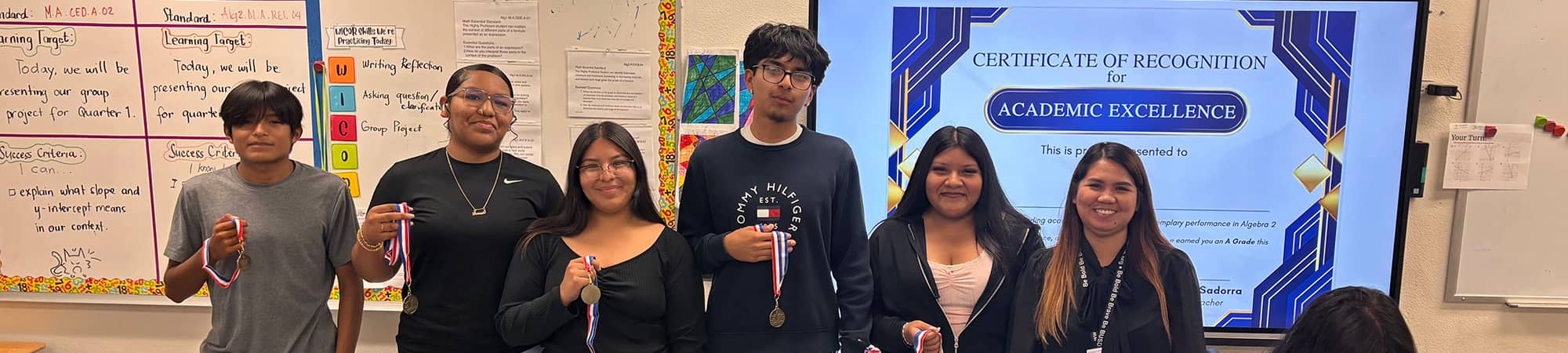 Students holding medals for Academic Excellence