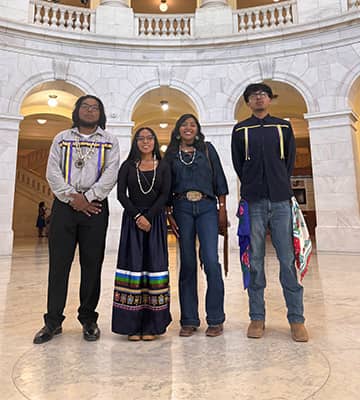 Students standing in the marble entryway of a large building