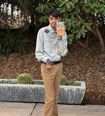 A student holding up a book