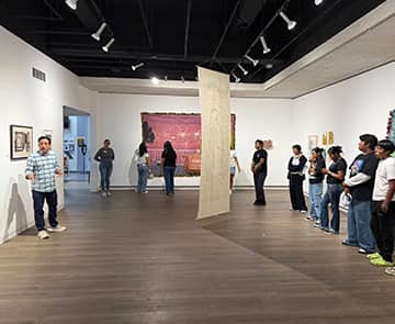 Students watching a guide at a museum