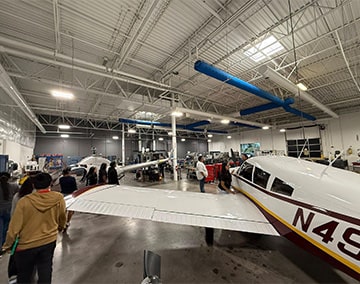 Students looking at airplanes