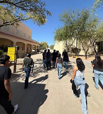 Students and adults walking in an outdoor plaza