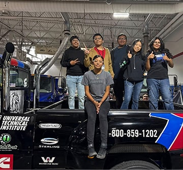 Students facing the camera while in the back of a truck