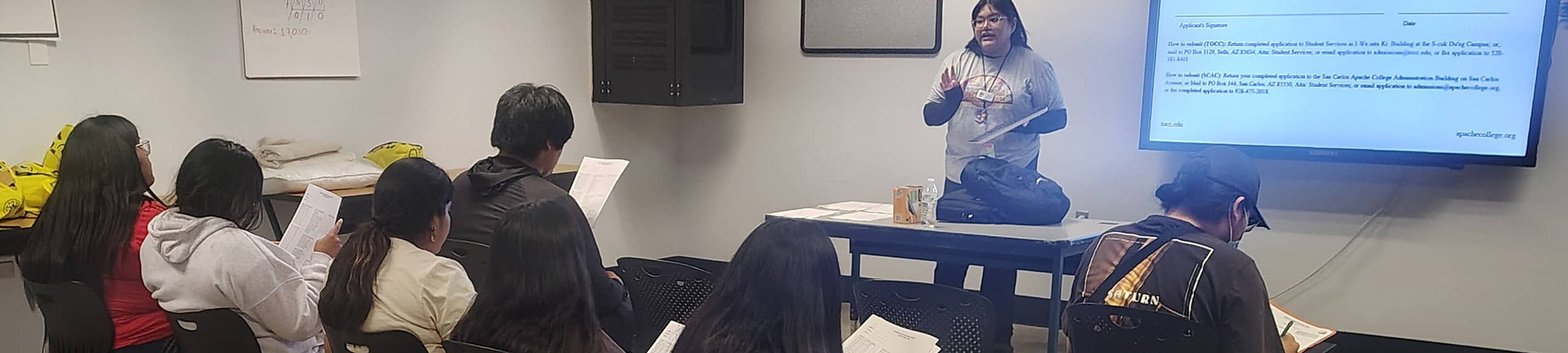 students and a teacher in a classroom