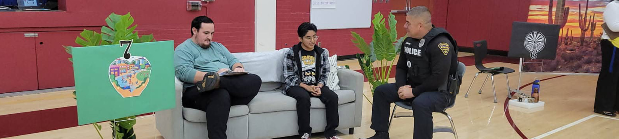 Police officer talking to a students and an adult