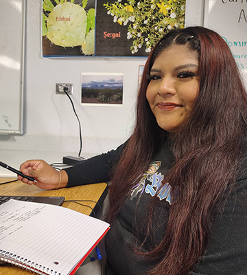 A student writing in a notebook
