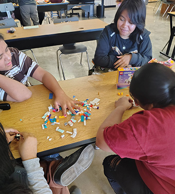 Students working together on a Lego kit