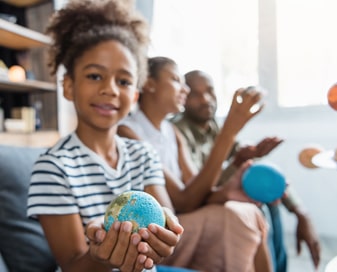 Student holding a globe