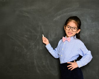 Girl standing at chalkboard